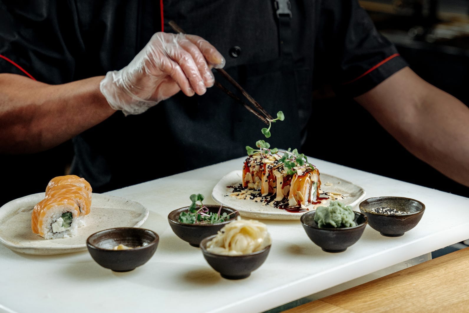 Chef finishing a plated dish with garnish
