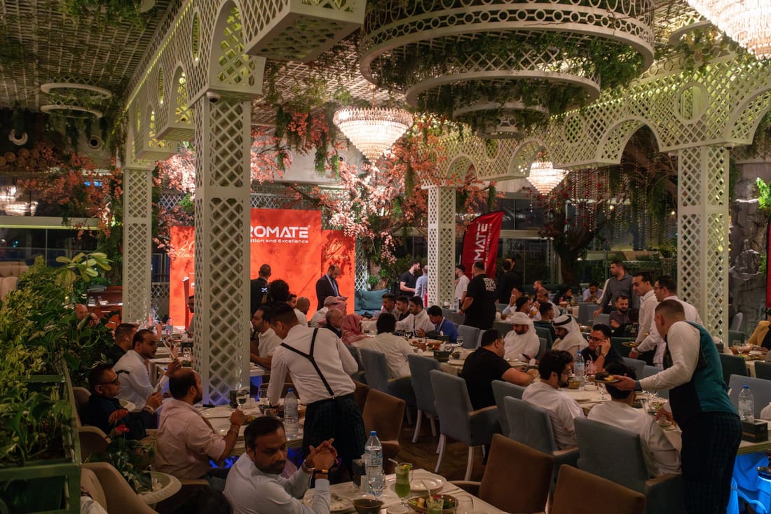 Guests seated at a garden-style event venue